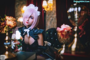 A woman in a maid outfit sitting on the floor next to a clock.