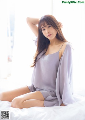 A woman in a blue dress posing for a picture.