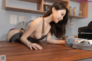 a woman in a gray apron holding a cup of coffee