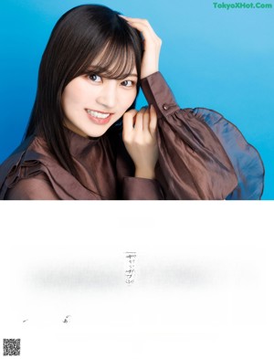 A woman with long black hair and bangs posing for a picture.