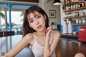 A young asian woman in a pink dress posing for the camera.