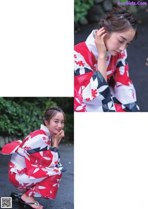 A woman in a red and white kimono standing next to a pole.