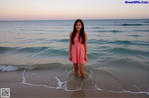 A woman in a blue shirt and yellow bikini posing for a picture.