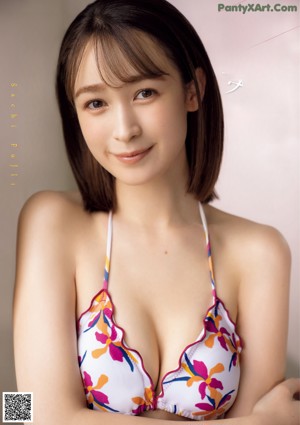 A woman in a bathing suit sitting on the floor.