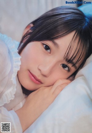 A young woman in a school uniform posing for a picture.