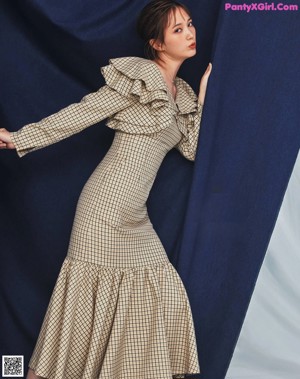 a woman in a sweater with her hands on her face