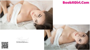 A woman in a white shirt sitting on a brown chair.