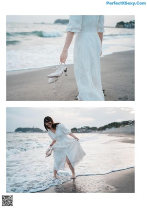 A woman in a white dress sitting on the beach.