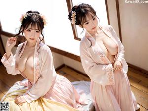 A woman in a pink and blue dress leaning against a wall.