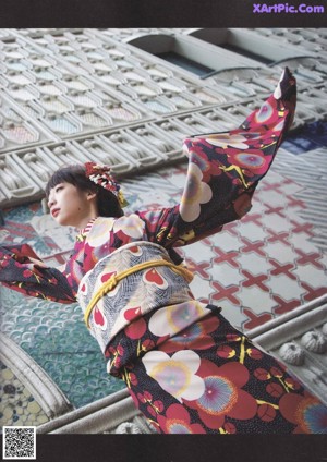 A woman laying on top of a bed next to a mirror.